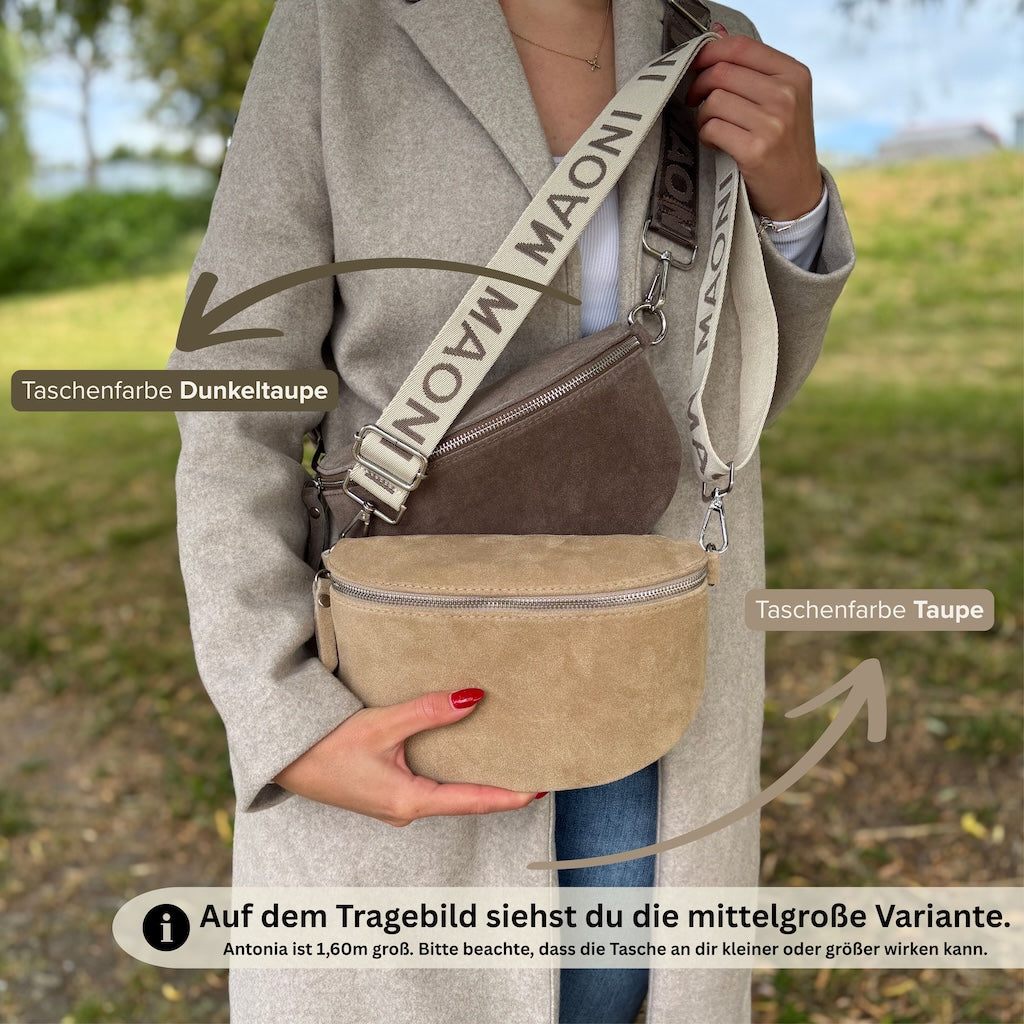 Frau zeigt zwei mittelgroße Bauchtaschen aus Wildleder im Farbvergleich – Dunkeltaupe getragen, Taupe in der Hand, Farbnamen und Modelgröße 1,60 m im Bild sichtbar